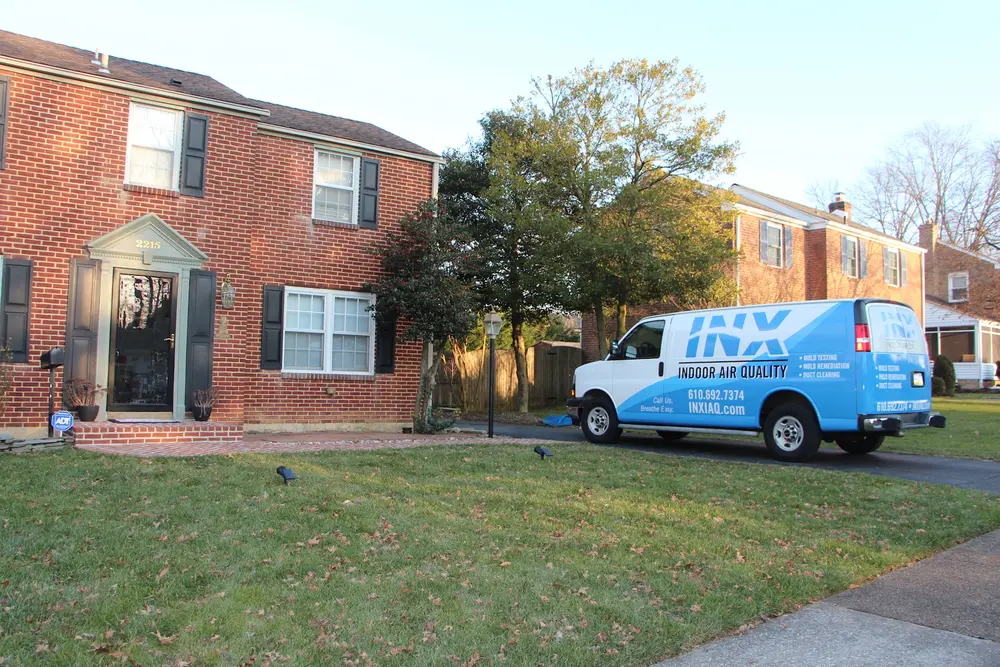 An INX Indoor Air Quality van parked outside of a client's home