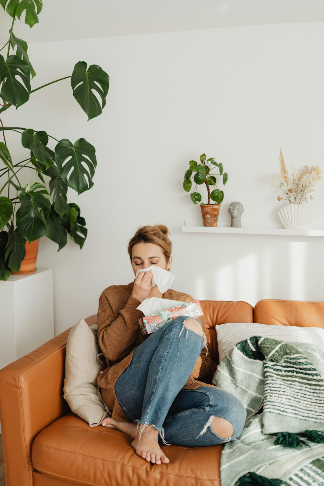 A woman experiencing symptoms of congestion brought on by mold exposure